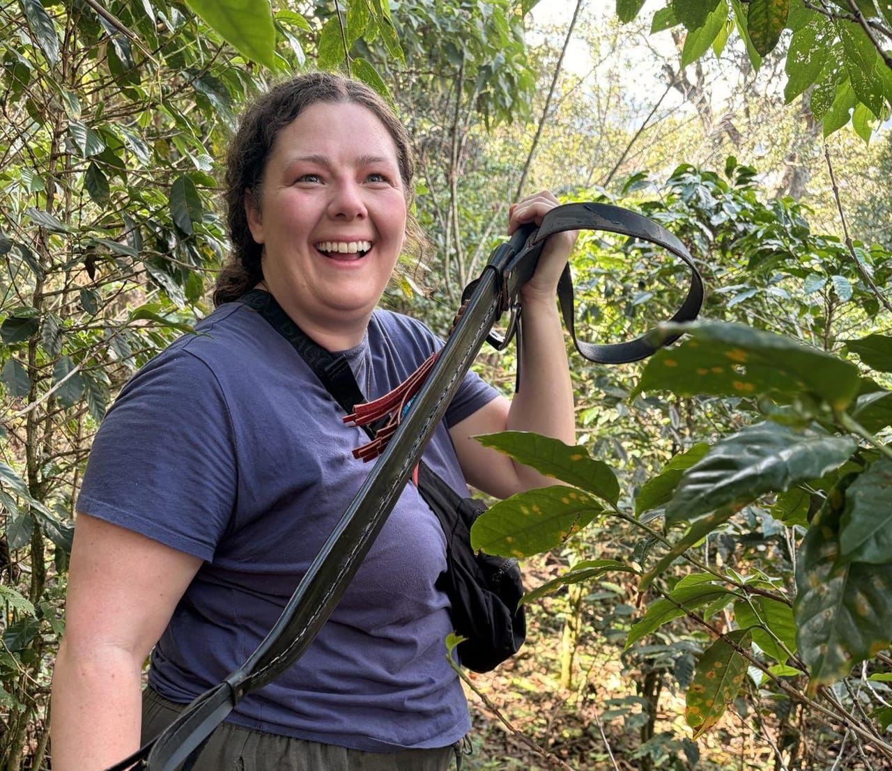 Carly laughing while holding up a machete during the Cafe Las Cristalinas coffee tour