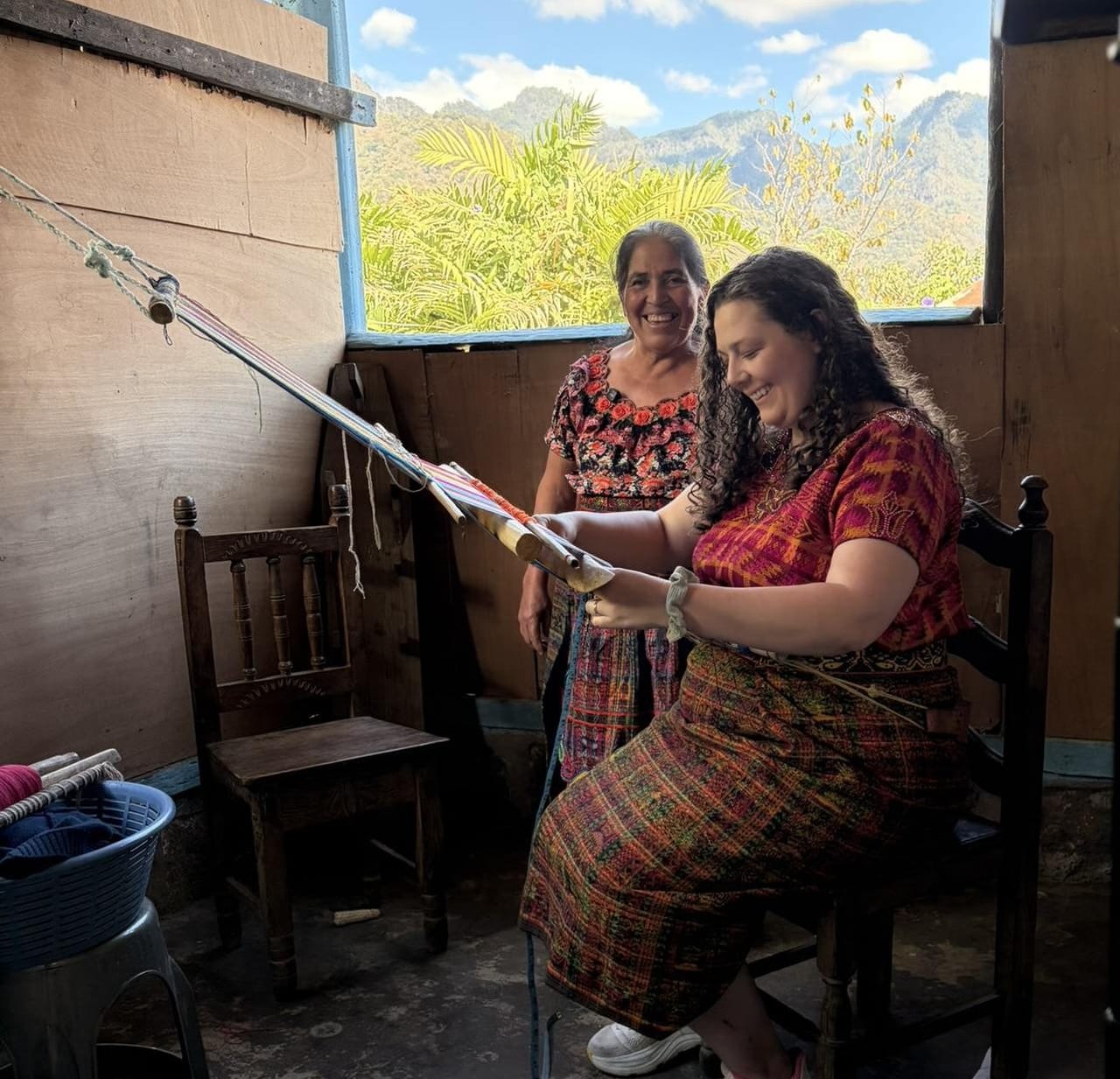 Patrona, a local weaver in San Juan La Laguna, smiling during a backstrap weaving workshop