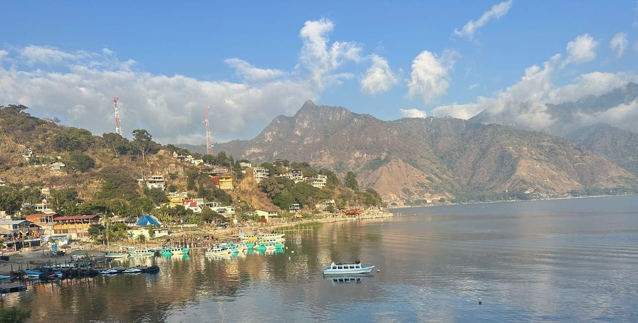 A quiet dock in San Pedro La Laguna in the early morning light, with lanchas moored along the shore